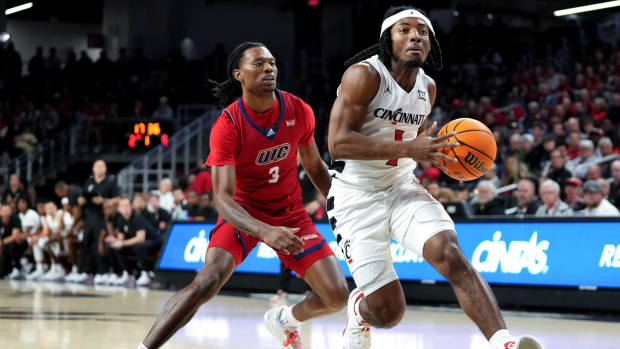 Cincinnati Bearcats guard Day Day Thomas (1) drives to the basket as Illinois-Chicago Flames guard CJ Jones (3) defends in the first half of a men s college basketball game between the Illinois-Chicago Flames and the Cincinnati Bearcats, Monday, Nov. 6, 2023, at Fifth Third Arena in Cincinnati.  